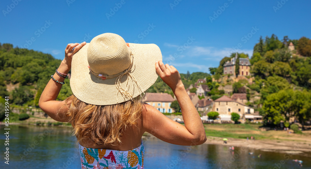Woman travelling in Dordogne,  village of Limeuil