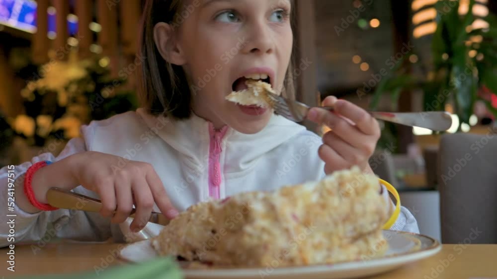 Beautiful girl sitting in cafe and eating creamy sweet cake. 4k video footage Beautiful girl sitting in cafe and eating creamy sweet cake. 4k video footage