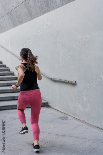 Young woman running fast on the ladder