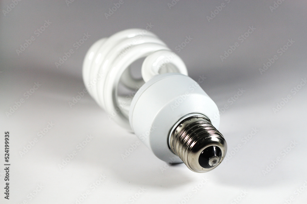 Glowing spiral light bulb isolated on white background. Eco energy saving light bulb concept Glowing spiral light bulb isolated on white background. Eco energy saving light bulb concept