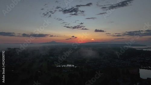 Aerial shot of the sun rising near Mount Baker with Whidbey Island in the foreground. photo