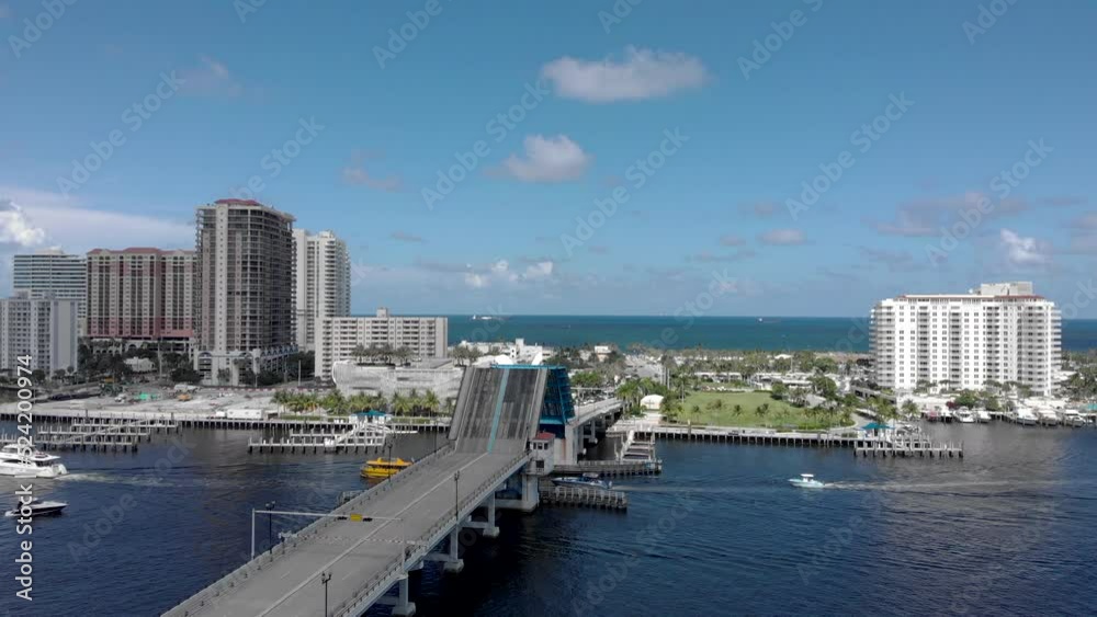 Forward moving drone shot with bridge up to allow boats underneath. waterway canal for boats and yachts in Fort Lauderdale Miami Florida beach life. Forward moving drone shot with bridge up to allow boats underneath. waterway canal for boats and yachts in Fort Lauderdale Miami Florida beach life.