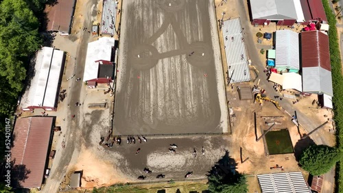 Overhead drone shot of a horse racing in an obstacle course. photo