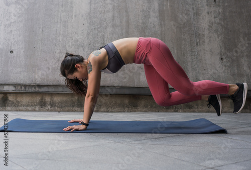 Asian woman exercising on yoga mat