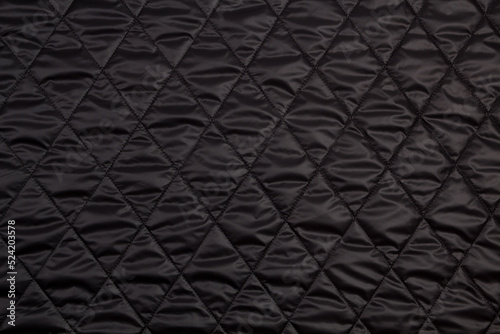 Top view quilted fabric. The texture of the blanket. Soft quilted blanket as background, top view