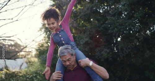 Fun grandfather carrying playful child on shoulders, having fun or playing in home garden, backyard or public park. Silly, goofy and little girl bonding with family, pretending to fly with senior man