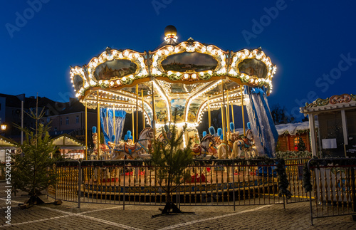 Decorated and illuminated carousel at Christmas market. Poznan