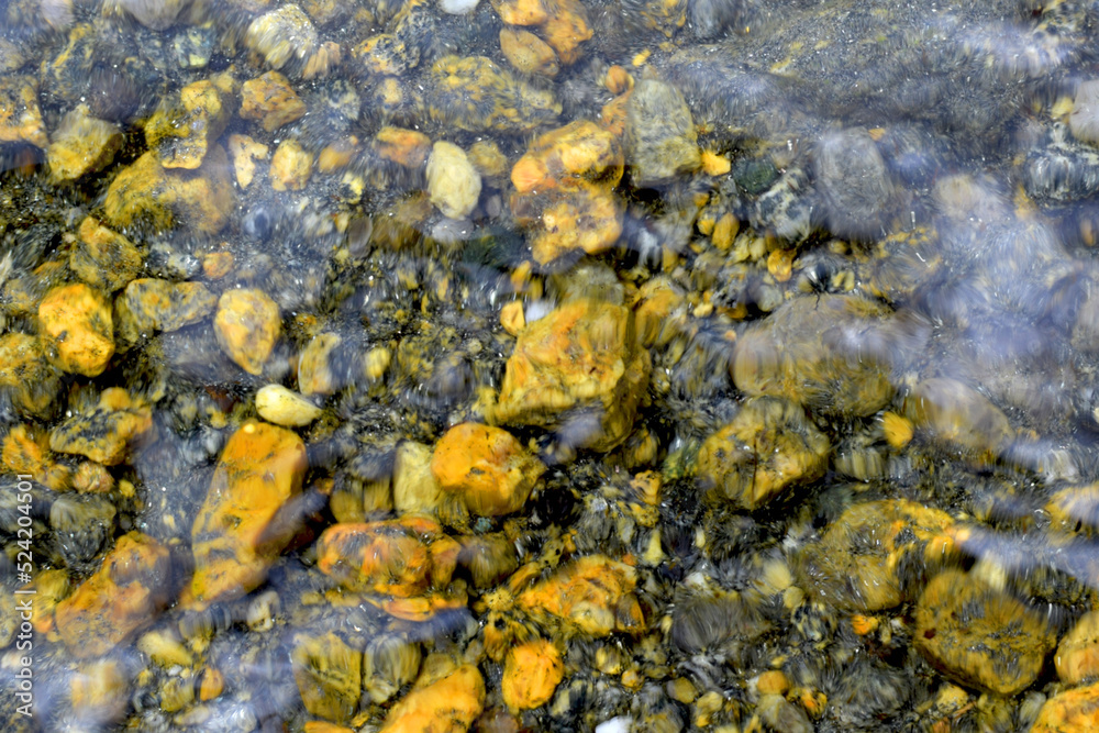 Abstract blurred background of sea stones. Natural colored sea stones underwater. Summer sea holiday concept. Abstract blurred background of sea stones. Natural colored sea stones underwater. Summer sea holiday concept.