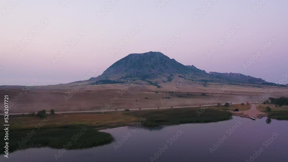 Aerial of motorcyclists on lakeside road in South Dakota, USA. Mountain scenic background Aerial of motorcyclists on lakeside road in South Dakota, USA. Mountain scenic background