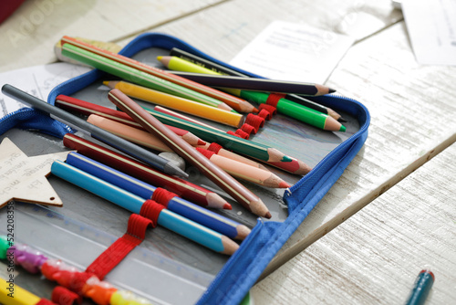 Colorful pencils in a box on a table, back to school, no person