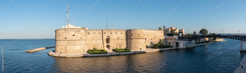 The Aragonese Castle and the Swing Bridge in Taranto canalboat at summer