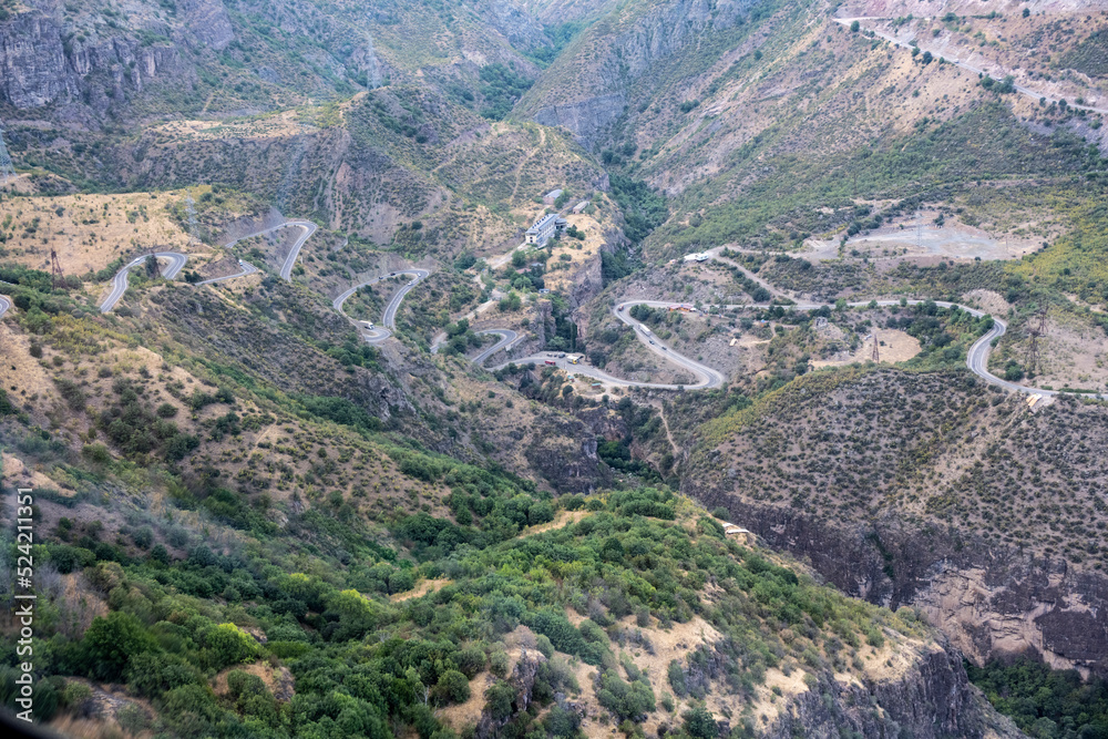 mountain gorge with a steep road and a funicular line in the mountains of Armenia
