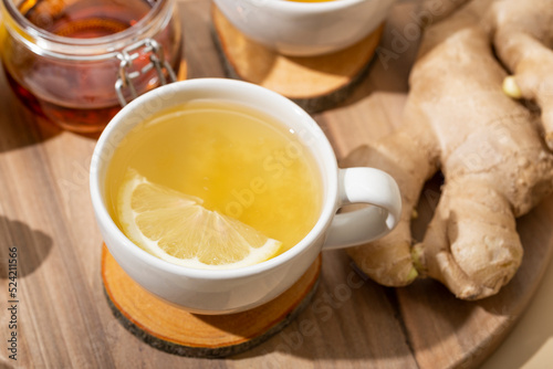  Cup of hot tea with ginger, honey and lemon close up