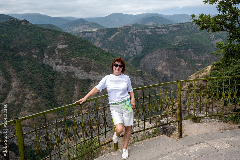 Naklejka premium woman tourist on the observation deck in a picturesque gorge in the mountains of Armenia