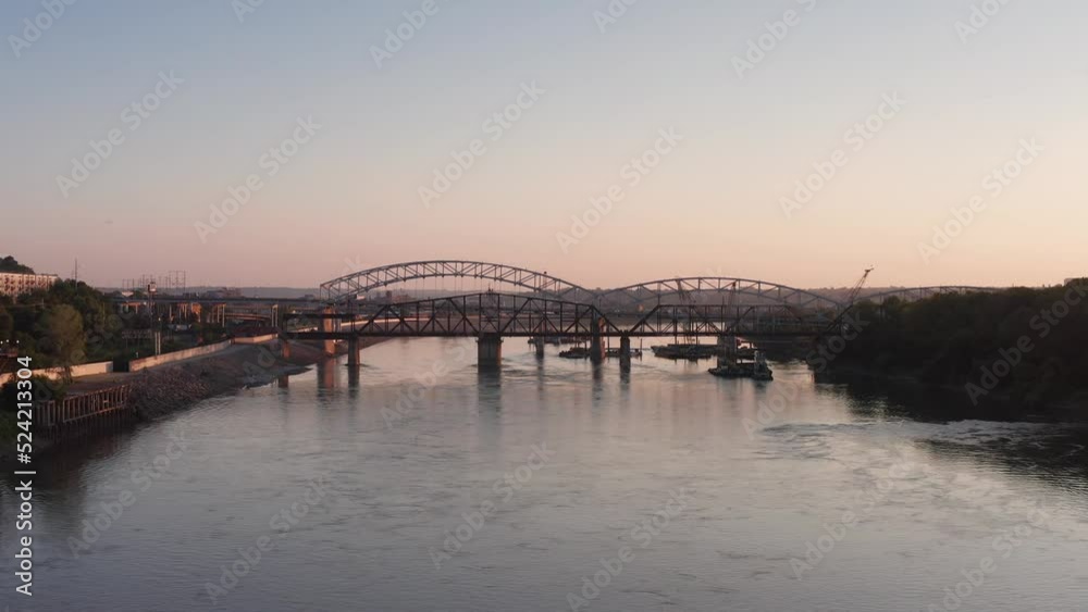 Low wide aerial shot of the historic Hannibal Bridge across the Missouri River at sunset. 4K Low wide aerial shot of the historic Hannibal Bridge across the Missouri River at sunset. 4K