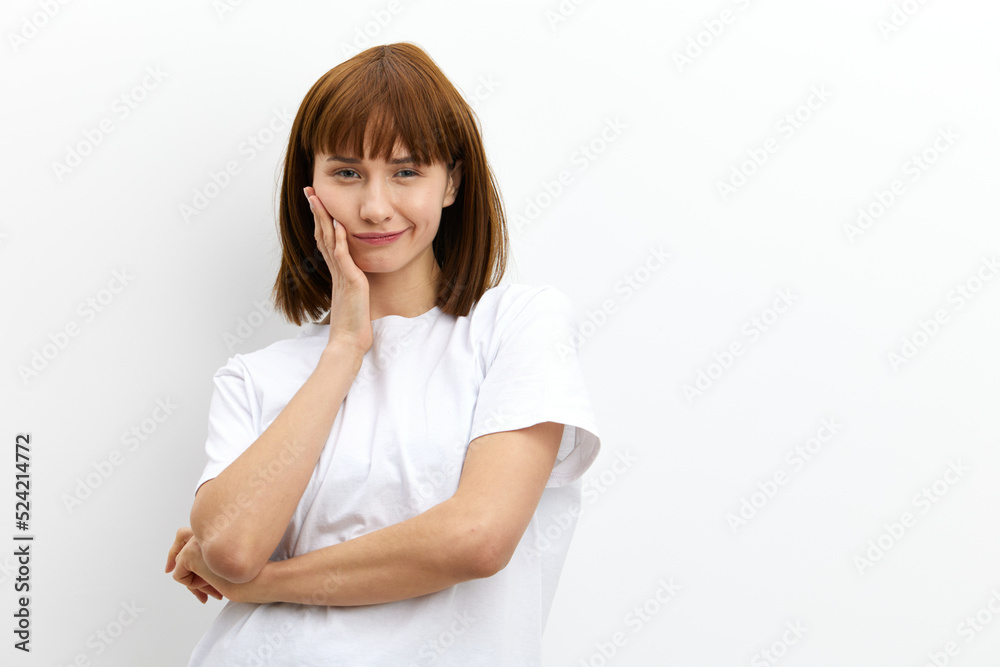 beautiful, playful, thoughtful woman stands holding her hand near her face in a relaxed pose, standing on a white background. Horizontal photo with an empty space for inserting an advertising layout beautiful, playful, thoughtful woman stands holding her hand near her face in a relaxed pose, standing on a white background. Horizontal photo with an empty space for inserting an advertising layout