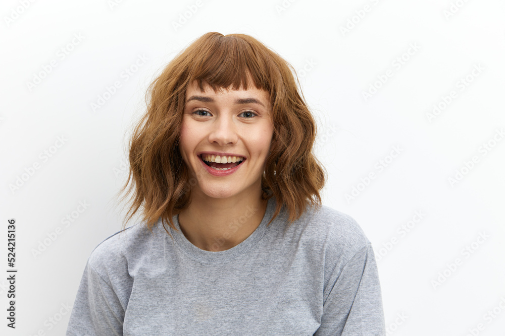 a sweet, beautiful, happy woman stands on a white background with beautiful, well-groomed, red hair and looks into the camera smiling pleasantly a sweet, beautiful, happy woman stands on a white background with beautiful, well-groomed, red hair and looks into the camera smiling pleasantly
