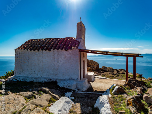 Fototapeta Naklejka Na Ścianę i Meble -  Sainst Anargyroi chapel and lens leaks under the bright sunlight, Aegina island, Greece.