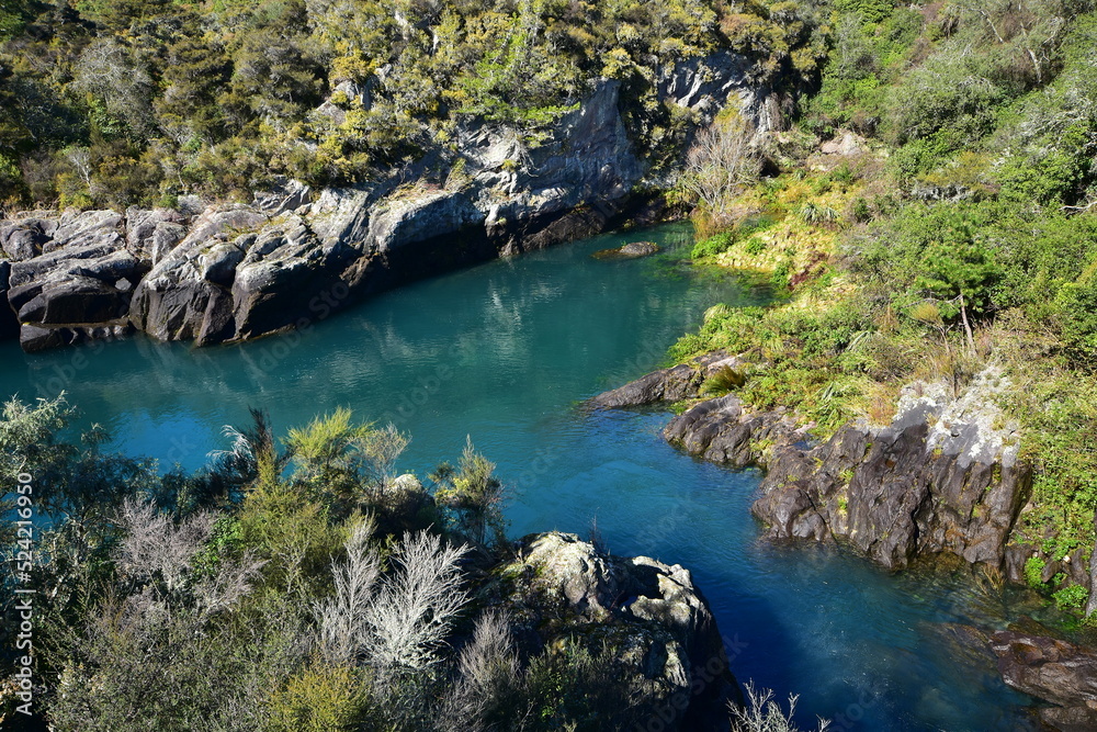 Calm turquoise waters of Waikato River near Aratiatia Rapids during period of closed spill gates. Location: Taupo New Zealand