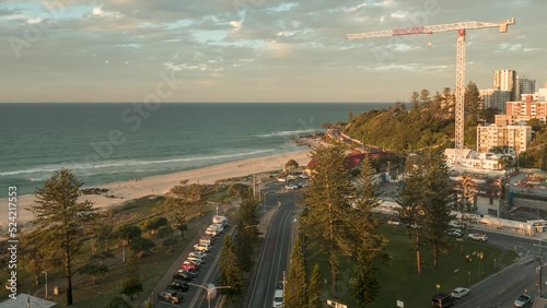 Time lapse of an elevated view of Kirra Point, Queensland, Australia, at sunset with clouds moving left to right.