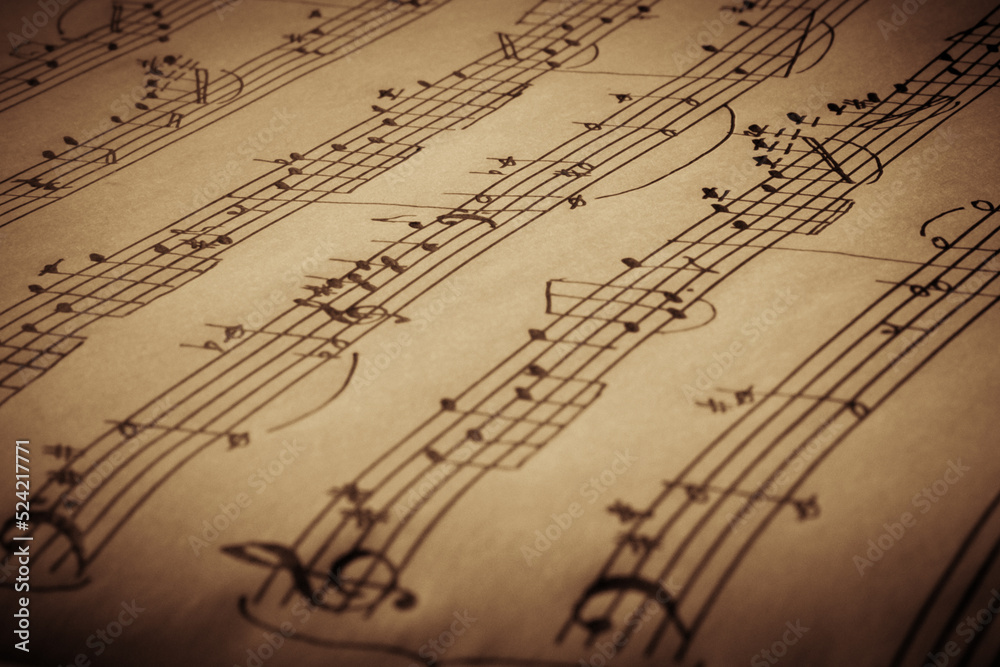 Old handwritten notes side view close up, music background, selective focus Old handwritten notes side view close up, music background, selective focus