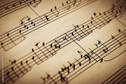 Old handwritten notes close up, music background, selective focus