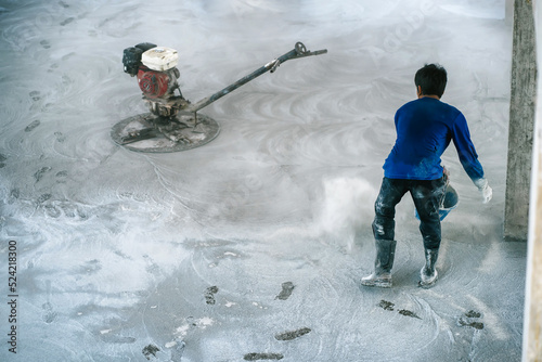 Construction workers use concrete polishers and hard floors.