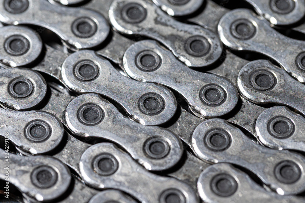 Upper Closeup View of Shiny Dirty Greasy Oiled Bicycle Chain As A Part of Metal Bicycle Equipment On Grey Tile Stony Background With Contrast Details Upper Closeup View of Shiny Dirty Greasy Oiled Bicycle Chain As A Part of Metal Bicycle Equipment On Grey Tile Stony Background With Contrast Details
