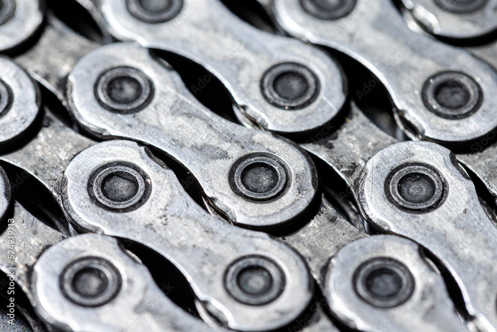 View of Shiny Dirty Greasy Oiled Bicycle Chain As A Part of Metal Bicycle Equipment On Grey Tile Stony Background With Contrast Details View of Shiny Dirty Greasy Oiled Bicycle Chain As A Part of Metal Bicycle Equipment On Grey Tile Stony Background With Contrast Details