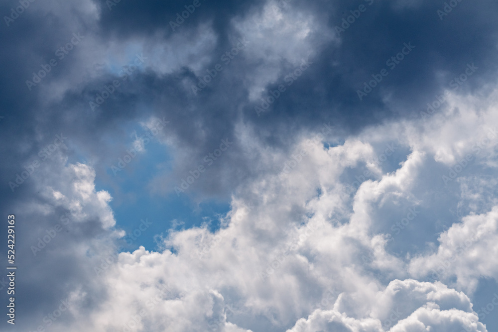 Fototapeta premium High layered white and gray epic clouds on blue sky. Heavenly cloudscape background