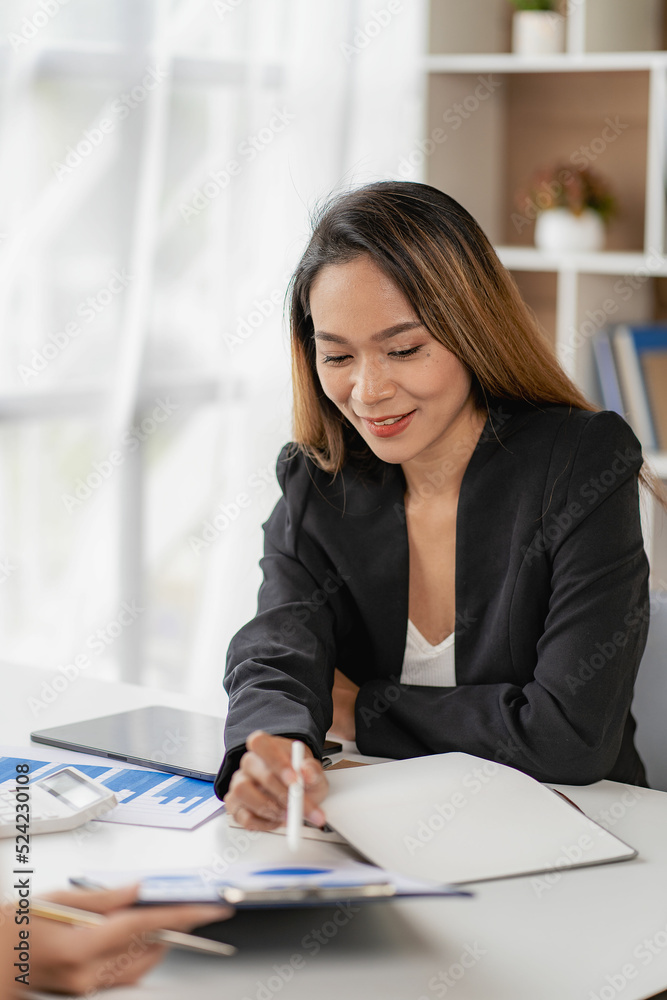 Asian business woman Use a laptop computer and work with the calculator documents on the desk. plan to analyze financial reports Invest in an office business plan Asian business woman Use a laptop computer and work with the calculator documents on the desk. plan to analyze financial reports Invest in an office business plan