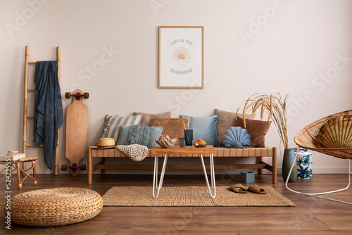 Sunny and bright space of living room with stylish sofa, pillows, coffee table, mock up poster frames, decorations, furnitures and personal accessories. Cozy home decor. Template. Summer vibe.