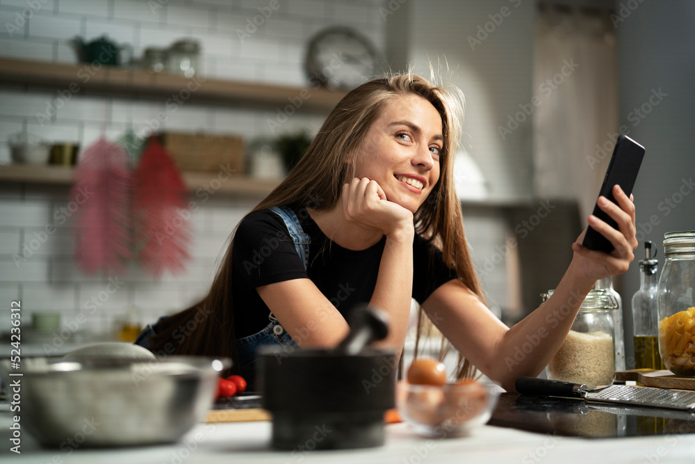 Young woman in kitchen. Beautiful woman making delicious food. Young woman in kitchen. Beautiful woman making delicious food.