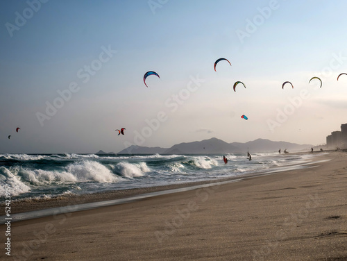 Kitesurfers catch the evening breeze on the Barra da Tijuca beach in Rio photo