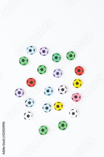 Wooden figures in the form of soccer balls on a white background