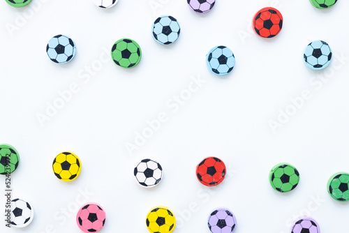 Wooden figures in the form of soccer balls on a white background