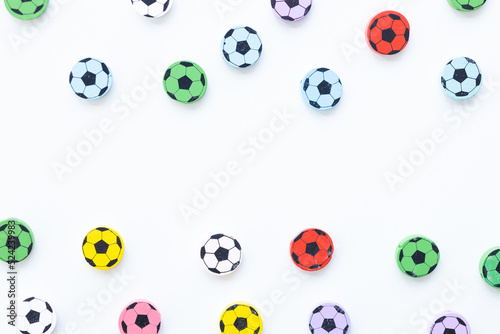 Wooden figures in the form of soccer balls on a white background