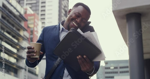 Busy, clumsy and stressed business man losing his paperwork outdoors in a rush to get to work. A careless employee walking in the city and talking on a phone call is running late in the morning photo