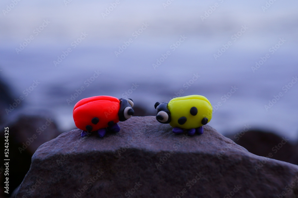 Naklejka premium Two ladybugs on a sunset background. A couple in love. Romantic mood. Looking at each other.