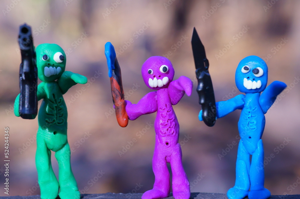 Obraz premium Figures of three zombies armed with a gun, a knife and an axe. Zombie apocalypse. Invasion of monsters.