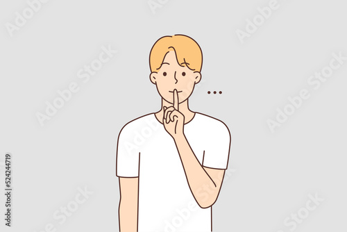 Man holding finger at lips ask for silence