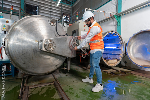 Mechanical aintenance engineer operate hand wheel shut off valve control boiler at the pressure tank during plant inoperation outage shutdown 
 photo