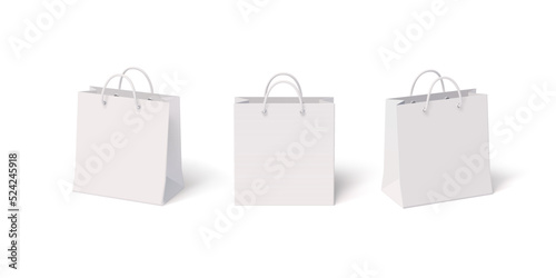 Set of white paper isolated shopping bags with front and side view. Vector realistic 3D blank mockup illustration of packets with plastic handles