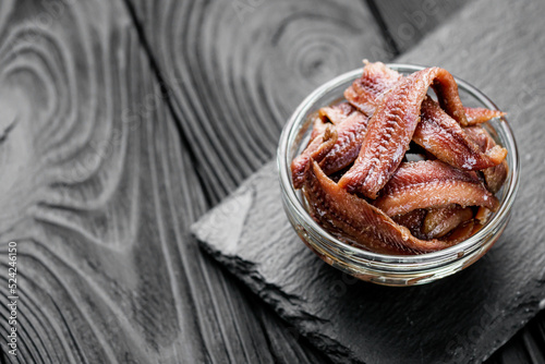 canned anchovy fillet on a black wooden rustic background