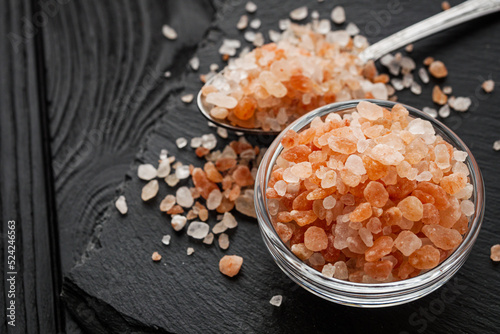 pink Himalayan salt on a black wooden rustic background