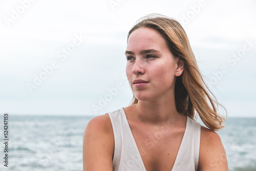Traveler girl resting on the beach near the sea. Eco travel, taking care of yourself physical and mental health. Slow life and sea holidays. work and leisure travel. Traveling outdoor