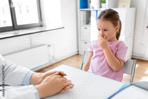 medicine  healthcare and pediatry concept - female doctor or pediatrician and coughing little girl patient on medical exam at clinic