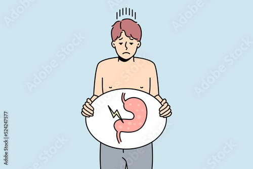 Unhealthy man suffer from indigestion problem. Unhappy sick guy holding image of sick body organ struggle with stomachache. Healthcare concept. Vector illustration. 