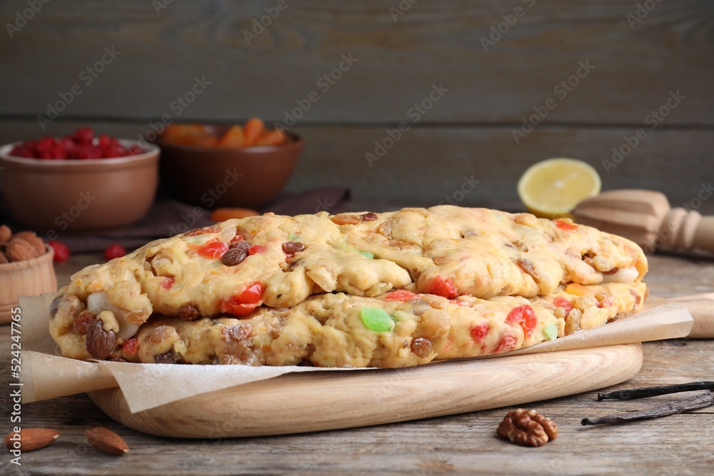 Unbaked Stollen with candied fruits and raisins on wooden table