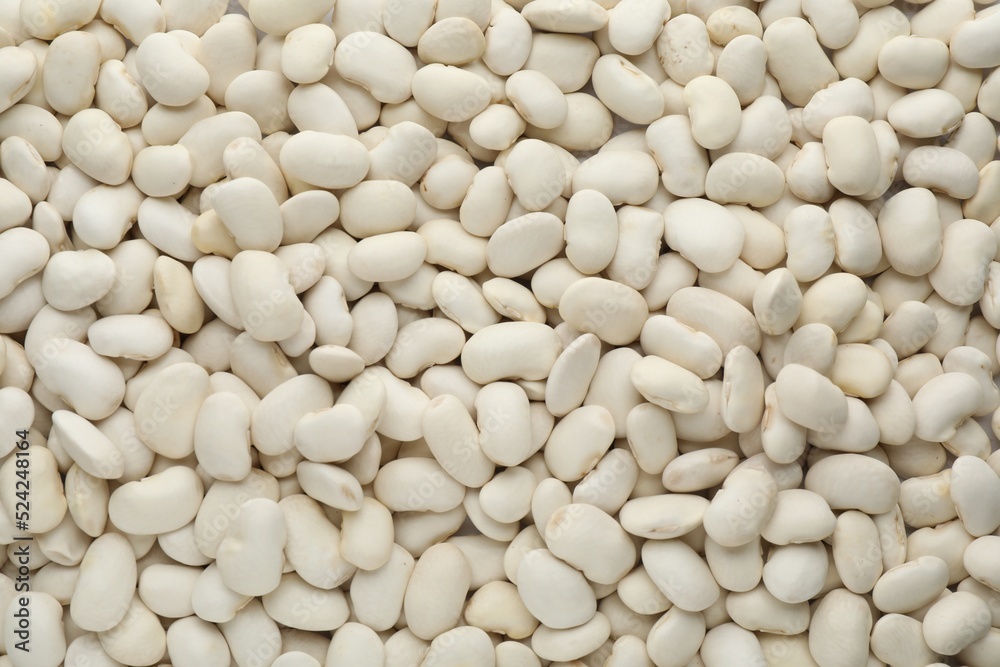 Pile of uncooked white beans as background, top view